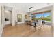 Bright dining room featuring wood floors, a large window, and seating for ten at 11324 E Diamond Cholla Dr, Scottsdale, AZ 85255
