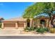 Inviting single-story home featuring a three-car garage and desert landscaping at 11324 E Diamond Cholla Dr, Scottsdale, AZ 85255