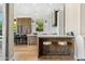 Bright and airy kitchen featuring custom wood and white cabinets with a large island and barstool seating at 11324 E Diamond Cholla Dr, Scottsdale, AZ 85255