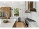 Modern kitchen featuring a large island with stainless steel appliances, custom cabinets and quartz countertops at 11324 E Diamond Cholla Dr, Scottsdale, AZ 85255