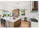 An open kitchen featuring custom wood and white cabinets, stainless appliances and a large island at 11324 E Diamond Cholla Dr, Scottsdale, AZ 85255