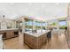 An open concept kitchen flowing to the outdoor patio and Gathering room featuring a large island with seating at 11324 E Diamond Cholla Dr, Scottsdale, AZ 85255
