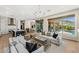 Spacious living room that leads to the kitchen and outdoor seating area with a pool at 11324 E Diamond Cholla Dr, Scottsdale, AZ 85255