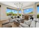 Bright living room featuring a fireplace, large windows with scenic views, and stylish furnishings at 11324 E Diamond Cholla Dr, Scottsdale, AZ 85255