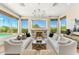 Bright living room featuring a fireplace, large windows with scenic views, and stylish furnishings at 11324 E Diamond Cholla Dr, Scottsdale, AZ 85255