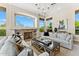 Bright living room featuring a fireplace, large windows with scenic views, and stylish furnishings at 11324 E Diamond Cholla Dr, Scottsdale, AZ 85255
