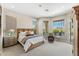 Bright main bedroom with natural light from large windows and view of outdoor patio at 11324 E Diamond Cholla Dr, Scottsdale, AZ 85255