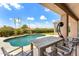 Inviting outdoor dining area next to the pool, with desert landscaping and mountain views at 11324 E Diamond Cholla Dr, Scottsdale, AZ 85255
