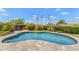 Sparkling pool surrounded by lush landscaping and a stone patio at 11324 E Diamond Cholla Dr, Scottsdale, AZ 85255
