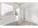 Bright bathroom features a large garden tub and a walk-in shower at 11957 W Daley Ln, Sun City, AZ 85373