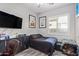 Cozy bedroom with a sleek desk and a bright window at 11957 W Daley Ln, Sun City, AZ 85373