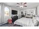 Relaxing bedroom with mirrored closet doors, white linens, ceiling fan and decorative window at 11957 W Daley Ln, Sun City, AZ 85373