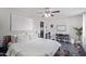 Bright bedroom with ceiling fan, desk, and a large decorative painting on the wall at 11957 W Daley Ln, Sun City, AZ 85373