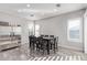 Bright dining room featuring modern finishes, marble floors and windows with plantation shutters at 11957 W Daley Ln, Sun City, AZ 85373