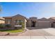 Charming single-story home featuring a three-car garage and low maintenance desert landscaping at 11957 W Daley Ln, Sun City, AZ 85373