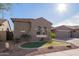 Charming single-story home featuring a three-car garage and low maintenance desert landscaping at 11957 W Daley Ln, Sun City, AZ 85373