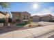 Charming single-story home featuring a three-car garage and low maintenance desert landscaping at 11957 W Daley Ln, Sun City, AZ 85373