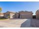 Charming single-story home featuring a three-car garage and low maintenance desert landscaping at 11957 W Daley Ln, Sun City, AZ 85373