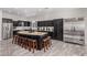 Spacious kitchen featuring a large center island, stainless appliances and black cabinetry at 11957 W Daley Ln, Sun City, AZ 85373