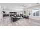 Bright living room with an open floor plan, marble floors, and dark furniture at 11957 W Daley Ln, Sun City, AZ 85373