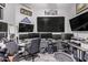 Spacious home office with multiple screens and comfortable seating, ideal for productivity at 11957 W Daley Ln, Sun City, AZ 85373