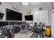 Well-equipped home office with multiple monitors, golf gear, and ample workspace at 11957 W Daley Ln, Sun City, AZ 85373