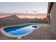 Backyard pool with brick paver patio, desert landscaping, and BBQ gazebo at 11957 W Daley Ln, Sun City, AZ 85373