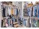 Expansive walk-in closet with custom shelving and plenty of storage space at 11957 W Daley Ln, Sun City, AZ 85373