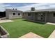Well-kept backyard with a detached garage or shed and artificial turf at 12230 N 47Th Dr, Glendale, AZ 85304