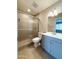 Well-lit bathroom with a glass shower door, single vanity and modern finishes at 12230 N 47Th Dr, Glendale, AZ 85304