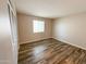 Cozy bedroom featuring wood floors and a window offering natural light at 12230 N 47Th Dr, Glendale, AZ 85304