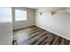 Comfortable room with wood-style flooring, floating shelves, and a window at 12230 N 47Th Dr, Glendale, AZ 85304