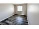 Cozy bedroom with wood-style flooring and a window bringing in natural light at 12230 N 47Th Dr, Glendale, AZ 85304