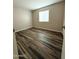 Cozy bedroom featuring wood-look floors, neutral paint, and window allowing for natural light at 12230 N 47Th Dr, Glendale, AZ 85304