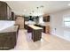 Modern kitchen with custom cabinets, kitchen island, and tiled floors at 12230 N 47Th Dr, Glendale, AZ 85304