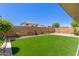 A bright and sunny backyard with artifical turf and block fence for added privacy at 12425 W Willow Ave Ave, El Mirage, AZ 85335