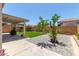 Backyard with hardscape, artificial turf, and covered patio. Desert landscaping at 12425 W Willow Ave Ave, El Mirage, AZ 85335