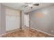 Neutral bedroom featuring tile floors, closet and a window with bright, natural light at 12425 W Willow Ave Ave, El Mirage, AZ 85335