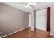 Comfortable bedroom featuring hardwood floors, a ceiling fan and closet for easy organization at 12425 W Willow Ave Ave, El Mirage, AZ 85335