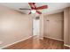 Comfortable bedroom featuring hardwood floors, a ceiling fan and a closet for easy organization at 12425 W Willow Ave Ave, El Mirage, AZ 85335