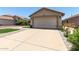Charming single-story home featuring a beige exterior, a two car garage, and meticulous landscaping at 12425 W Willow Ave Ave, El Mirage, AZ 85335