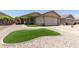 Charming single-story home featuring a beige exterior, a two car garage, and meticulous landscaping at 12425 W Willow Ave Ave, El Mirage, AZ 85335