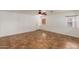 Open-concept living room with neutral walls, tile floors, and a ceiling fan at 12425 W Willow Ave Ave, El Mirage, AZ 85335