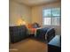 Cozy bedroom with a twin bed, soft lighting, and a modern dresser at 13041 N 51St Dr, Glendale, AZ 85304