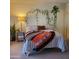 Bedroom featuring cozy decor with a patterned blanket and indoor hanging plants at 13041 N 51St Dr, Glendale, AZ 85304