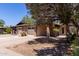 Beautiful single-story home featuring brick accents, a two-car garage, and a mature tree providing shade at 13041 N 51St Dr, Glendale, AZ 85304