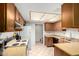 Traditional kitchen with wooden cabinets, tile floor, and essential appliances at 13041 N 51St Dr, Glendale, AZ 85304