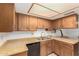 Bright kitchen featuring wood cabinets, dual basin sink and black appliances at 13041 N 51St Dr, Glendale, AZ 85304