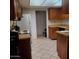 Traditional kitchen design with tiled floors and a combination of light and dark wood cabinetry at 13041 N 51St Dr, Glendale, AZ 85304
