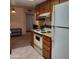 Functional kitchen area featuring essential appliances and neutral tiled flooring at 13041 N 51St Dr, Glendale, AZ 85304